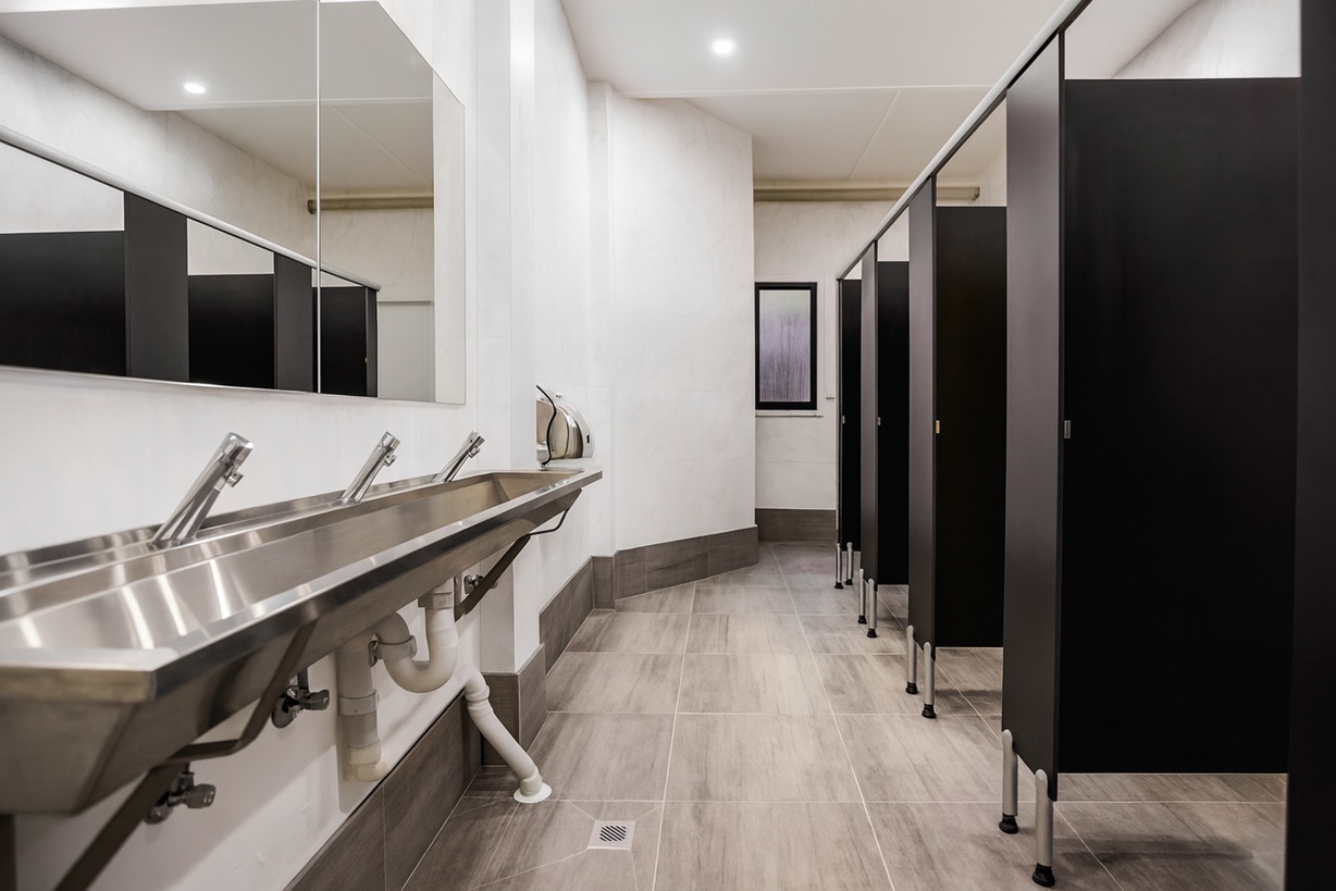 Elementary student easily using automatic soap dispenser