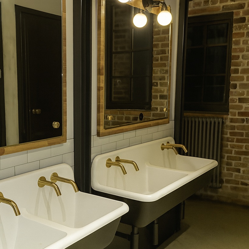 Close-up of sealed sensor on automatic soap dispenser in steamy environment